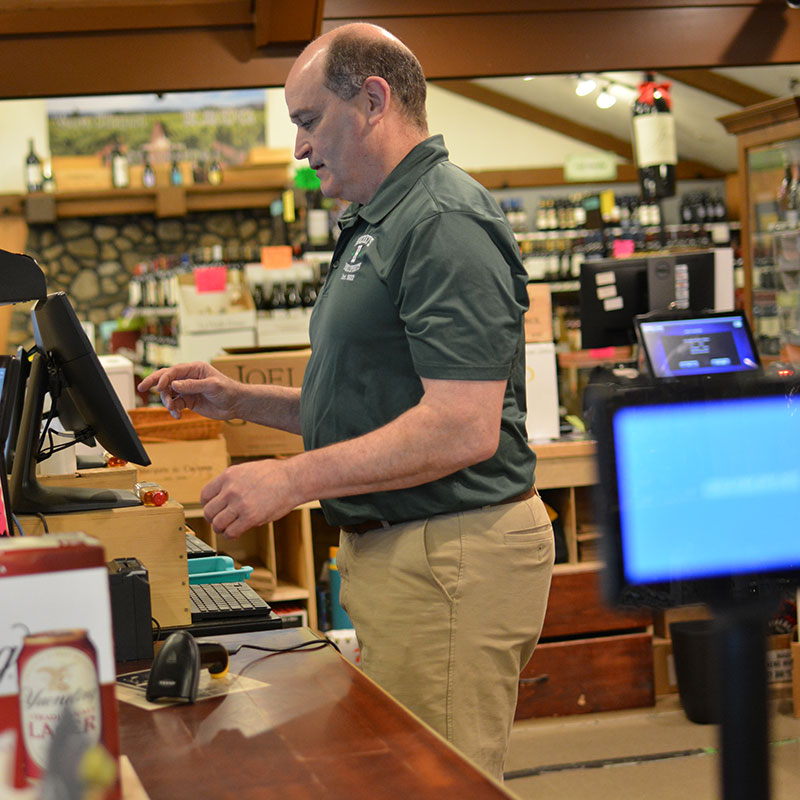 Hickey’s Wine & Spirits staff member at the register.