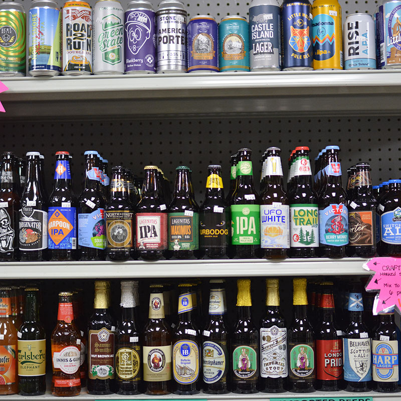 A selection of beer bottles and cans on shelves at Hickey's Wine & Spirits.