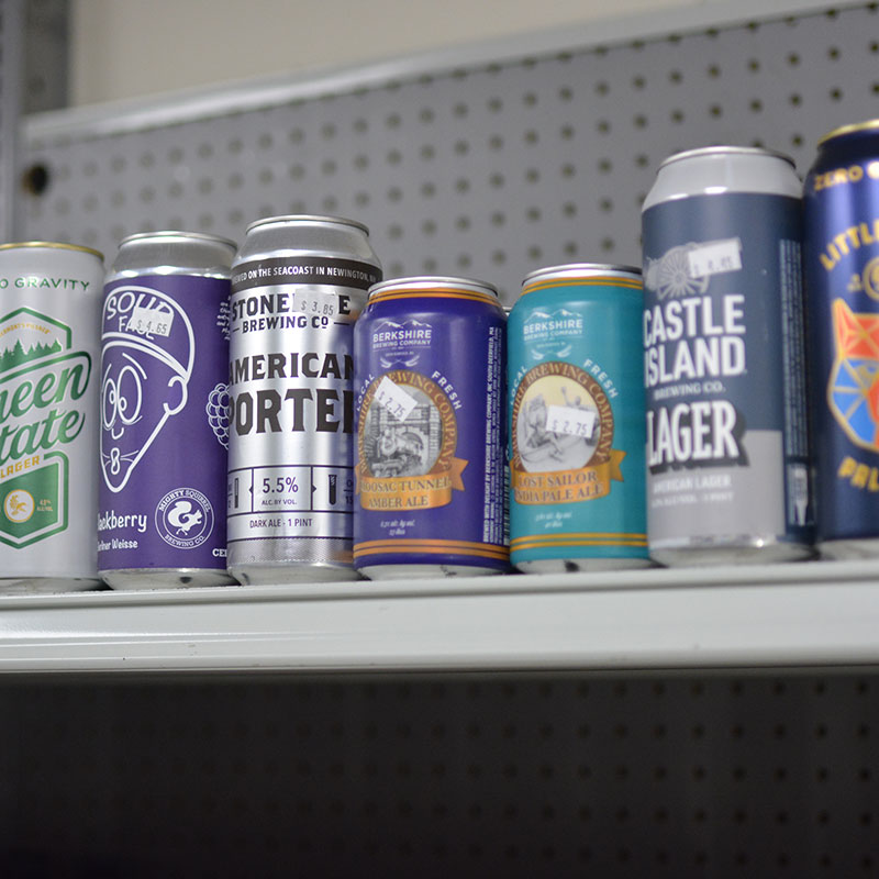 A selection of beer cans on shelves at Hickey's Wine & Spirits.