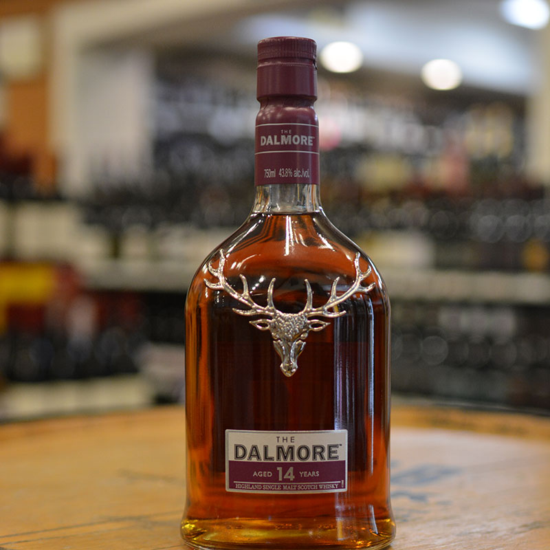 Bottle of single malt scotch whiskey sitting on a barrel head at Hickey's Wine & Spirits.